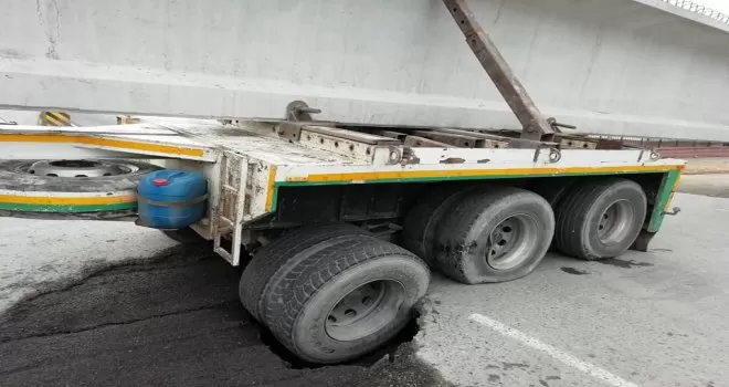 Köprü ayağı taşıyan tır kara yolunda açtığı çukura düştü
